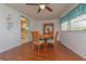 Cozy dining room with a round table, wooden chairs, and a view to the kitchen at 3301 Alt 19 # 819, Palm Harbor, FL 34683