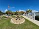 This beautiful community building features lush landscaping, an ornate fountain, and an American flag at 3301 Alt 19 # 819, Palm Harbor, FL 34683