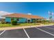 Exterior shot of a blue building surrounded by green landscaping and a paved parking lot at 3301 Alt 19 # 819, Palm Harbor, FL 34683