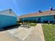 Exterior back view of a blue building featuring green landscaping, bike rack, and door entry at 3301 Alt 19 # 819, Palm Harbor, FL 34683