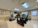 Bright fitness center featuring exercise equipment, mirrors, and natural light from a window at 3301 Alt 19 # 819, Palm Harbor, FL 34683