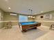 This game room features a full-sized pool table, comfortable seating, and ample lighting for friendly competition at 3301 Alt 19 # 819, Palm Harbor, FL 34683