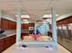 Open kitchen view featuring stainless steel appliances, wood cabinets, and light blue walls at 3301 Alt 19 # 819, Palm Harbor, FL 34683