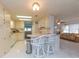Bright kitchen with bar seating and white appliances, flowing into the living area at 3301 Alt 19 # 819, Palm Harbor, FL 34683