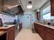 Galley style kitchen featuring stainless steel appliances, tile backsplash, and wood cabinets at 3301 Alt 19 # 819, Palm Harbor, FL 34683