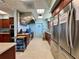 Galley style kitchen featuring stainless steel appliances, tile backsplash, and wood cabinets at 3301 Alt 19 # 819, Palm Harbor, FL 34683