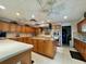 Bright eat-in kitchen boasts wooden cabinets, central island, and stainless steel range at 3301 Alt 19 # 819, Palm Harbor, FL 34683