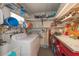 Organized laundry room features a washing machine, dryer, utility sink, and ample storage shelving at 3301 Alt 19 # 819, Palm Harbor, FL 34683