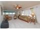 Bright living room with comfortable armchairs and a sofa, illuminated by natural light and ceiling fan at 3301 Alt 19 # 819, Palm Harbor, FL 34683