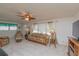 Inviting living room with comfortable seating, fan, and large windows with sheer curtains at 3301 Alt 19 # 819, Palm Harbor, FL 34683