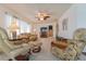 Inviting living room featuring a plush sofa, armchair, entertainment center, and a ceiling fan at 3301 Alt 19 # 819, Palm Harbor, FL 34683