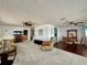 Open concept living room area showing a dining area, ceiling fans and access to different parts of the home at 3301 Alt 19 # 819, Palm Harbor, FL 34683
