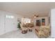 Spacious living room featuring plush seating, a ceiling fan, and a view of the front door at 3301 Alt 19 # 819, Palm Harbor, FL 34683