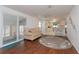 Open floor plan living room with sliding doors, laminate flooring, and view of the kitchen at 3301 Alt 19 # 819, Palm Harbor, FL 34683