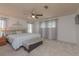 Spacious main bedroom with large bed, bench, and decoratively draped windows at 3301 Alt 19 # 819, Palm Harbor, FL 34683