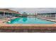 A large community pool that has lounge chairs surrounding it for residents to relax and catch some sun at 3301 Alt 19 # 819, Palm Harbor, FL 34683