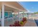 Community pool patio with tables and chairs underneath an awning next to the swimming pool at 3301 Alt 19 # 819, Palm Harbor, FL 34683