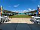 Community shuffleboard courts with seating areas on both sides of the courts for people to relax at 3301 Alt 19 # 819, Palm Harbor, FL 34683