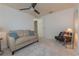 Cozy sitting room with sofa, chair, and neutral carpeting at 3301 Alt 19 # 819, Palm Harbor, FL 34683