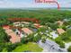 Aerial view of community featuring landscaping, pond and Lake Tarpon in the background at 3389 Crystal E Ct # J, Palm Harbor, FL 34685