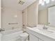 Clean bathroom featuring white tile, a bathtub, and a sink vanity with a mirror at 3389 Crystal E Ct # J, Palm Harbor, FL 34685