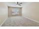 Bright bedroom with large window, neutral walls, and plush carpeting, creating a tranquil and inviting space at 3389 Crystal E Ct # J, Palm Harbor, FL 34685