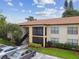 Exterior shot of this two story building with manicured landscaping and covered balcony at 3389 Crystal E Ct # J, Palm Harbor, FL 34685
