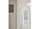 Neutral hallway featuring white-tiled floors, a closet, and access to other rooms in the home at 3389 Crystal E Ct # J, Palm Harbor, FL 34685