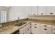 Kitchen view showcasing granite counters, undermount sink, and white cabinets at 3389 Crystal E Ct # J, Palm Harbor, FL 34685