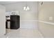 Kitchen eating area with overhead lighting and a full sized black refrigerator at 3389 Crystal E Ct # J, Palm Harbor, FL 34685