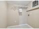 Functional laundry room with overhead shelving and utility connections for laundry appliances at 3389 Crystal E Ct # J, Palm Harbor, FL 34685