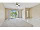 Living room featuring sliding glass doors to balcony and mix of tile and carpet flooring at 3389 Crystal E Ct # J, Palm Harbor, FL 34685