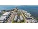 Breathtaking aerial view featuring waterfront access, nearby amenities, and community pool at 340 Causeway Blvd # 105, Dunedin, FL 34698