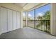 A screened lanai offers outdoor living with peaceful views of the surrounding neighborhood at 340 Causeway Blvd # 105, Dunedin, FL 34698