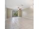 Bright living room with tile floors and sliding glass doors leading to outdoor space at 340 Causeway Blvd # 105, Dunedin, FL 34698
