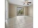 Open living room featuring tile floors and sliding doors to the outside at 340 Causeway Blvd # 105, Dunedin, FL 34698