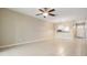 Open-concept living room featuring tile flooring, neutral paint, and a ceiling fan at 340 Causeway Blvd # 105, Dunedin, FL 34698