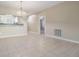 A modern living room with tile floors and view of the kitchen bar that connects to the kitchen at 340 Causeway Blvd # 105, Dunedin, FL 34698