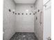 Gorgeous shower with accent tiling and pebble floor at 340 Causeway Blvd # 105, Dunedin, FL 34698