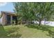 Spacious backyard featuring a covered patio, mature trees, and a well-maintained lawn perfect for outdoor enjoyment at 34447 Windknob Ct, Wesley Chapel, FL 33545