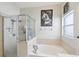 Clean and bright bathroom with a glass shower and separate soaking tub at 34447 Windknob Ct, Wesley Chapel, FL 33545