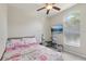 Carpeted bedroom features a large window and an exercise equipment set at 34447 Windknob Ct, Wesley Chapel, FL 33545