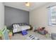 Gray accent bedroom features a large window and lots of toys at 34447 Windknob Ct, Wesley Chapel, FL 33545