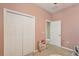 Light filled bedroom offering closet with white doors, and neutral walls at 34447 Windknob Ct, Wesley Chapel, FL 33545