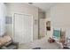 Neutral painted bedroom features a closet with white doors and toys at 34447 Windknob Ct, Wesley Chapel, FL 33545