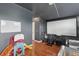 Bonus room featuring play area, projector screen, and hardwood floors at 34447 Windknob Ct, Wesley Chapel, FL 33545