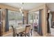Dining area with modern pendant lighting and a sliding glass door to the patio at 34447 Windknob Ct, Wesley Chapel, FL 33545
