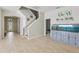 Welcoming foyer with tile floors, an aquarium and a staircase to the second level at 34447 Windknob Ct, Wesley Chapel, FL 33545