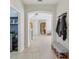 Inviting hallway with tile flooring, archways, and convenient access to the laundry room at 34447 Windknob Ct, Wesley Chapel, FL 33545