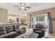 Open concept living room featuring tile floors and access to the kitchen and outdoor seating at 34447 Windknob Ct, Wesley Chapel, FL 33545